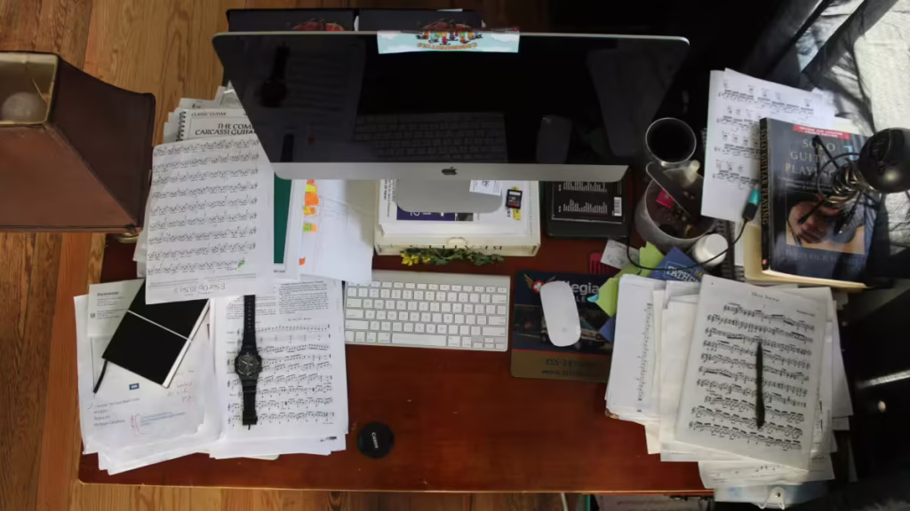 Cluttered desk showing the need for a minimalist desk setup.