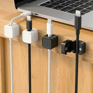 TidySetup magnetic cable organizer clips holding braided charging cables on oak desk edge